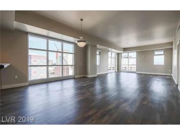 Bright living room with hardwood floors and large windows offering city views at 150 N Las Vegas Blvd # 804, Las Vegas, NV 89101