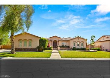 Charming single-story home featuring a well-manicured lawn, desert landscaping and beautiful architecture at 215 Great Gable Dr, Las Vegas, NV 89183