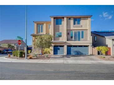 A modern two-story home with a three car garage, desert landscaping, and neutral color palette at 5946 Ancient Peaks Ave, Las Vegas, NV 89141