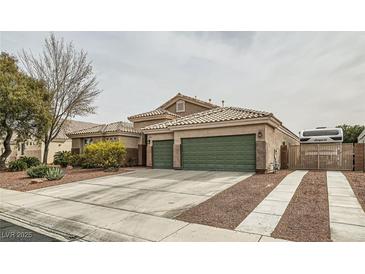 Single-story home featuring a three-car garage, tile roof, desert landscaping, and RV parking at 7690 Blue Whirlpool St, Las Vegas, NV 89131