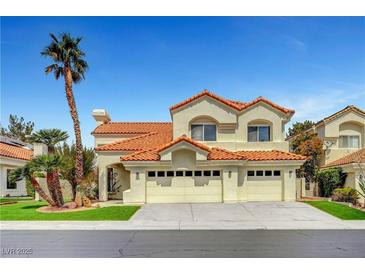 Charming two-story home featuring a three-car garage, desert landscaping, and a classic red tile roof at 8132 Bay Harbor Dr, Las Vegas, NV 89128