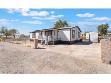 Charming single-story home with a gravel driveway and fenced yard, offering a cozy and private living space at , Las Vegas, NV 89156