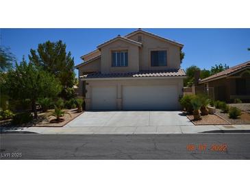 Charming two-story home featuring a well-manicured lawn and a two-car garage, perfect for suburban living at 10417 Niagara Falls Ln, Las Vegas, NV 89144