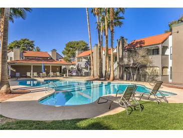 Inviting community pool area with lounge chairs, shaded seating, and well-maintained landscaping on a sunny day at 3411 Sunfish Dr # B, Henderson, NV 89014