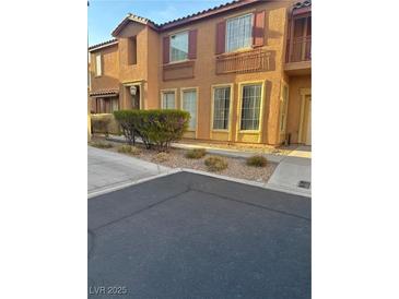 Charming two-story townhouse with desert landscaping and warm, inviting facade at 3637 Pinnate Dr, Las Vegas, NV 89147