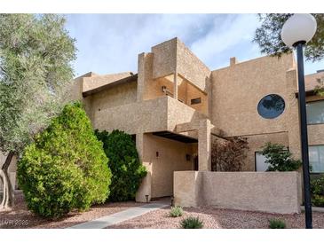 Inviting condo featuring a unique facade, covered entry, and mature landscaping at 3949 S Torrey Pines Dr, Las Vegas, NV 89103
