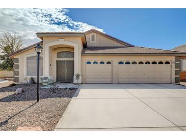 Inviting single-story home with a well-maintained front yard and a spacious three-car garage at 5419 Sharpei Ct, Las Vegas, NV 89131