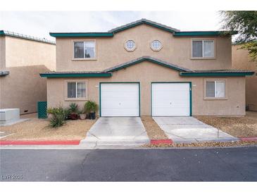 Well-maintained home featuring two garages and desert landscaping for a clean, appealing look at 5771 Ritter Ln, Las Vegas, NV 89118