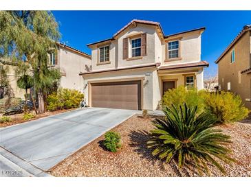 Charming two-story home featuring a neutral stucco exterior, complemented by a well-maintained front yard and two-car garage at 6476 Little Harbor Ct, Las Vegas, NV 89141