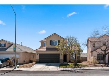 Charming two-story home featuring an attached two-car garage and desert landscaping at 8125 Boxberry Ave, Las Vegas, NV 89131