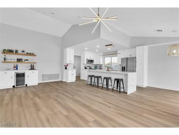 Bright kitchen with stainless steel appliances, white cabinets, and modern light fixture at 8812 Stoney Point Dr, Las Vegas, NV 89134