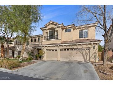 Elegant two-story home with a spacious three-car garage and a meticulously maintained front yard at 10748 Aldrovandi Dr, Las Vegas, NV 89141