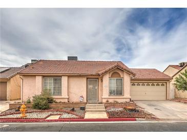 Charming single-story home featuring a red tile roof and a well-maintained, low-water landscaping design at 2735 Poppyseed Way, Las Vegas, NV 89142