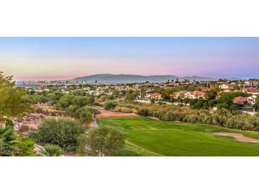 Scenic view of a lush golf course with city and mountain views, offering a serene and picturesque setting at 2994 San Lorenzo Ct, Henderson, NV 89052