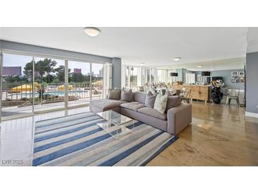 Bright living room with large windows offering pool views and comfortable modern furnishings at 3111 Bel Air Dr # 3C, Las Vegas, NV 89109