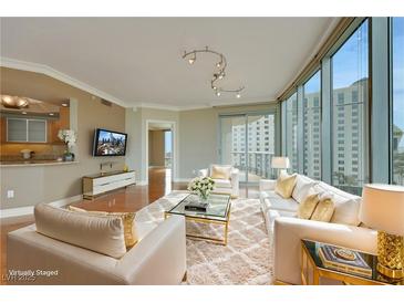 Bright living room featuring a fluffy rug, floor-to-ceiling windows, and contemporary furnishings at 322 Karen Ave # 708, Las Vegas, NV 89109