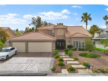 Charming two-story home with a terracotta roof, landscaped front yard, and a spacious three-car garage at 5205 Sandy Cactus Ln, Las Vegas, NV 89149