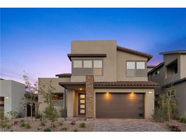 Modern two-story home boasts a finished driveway, manicured yard, and a stylish facade with a two-car garage at 532 Crown Mesa Ave, Las Vegas, NV 89138