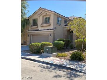 Charming two-story home with well-manicured landscaping and a welcoming facade at 7439 S Pioneer Way, Las Vegas, NV 89113