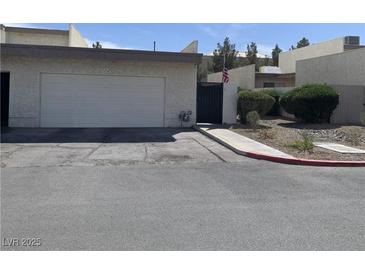 Charming single-story home featuring a two-car garage, desert landscaping, and a gated entrance at 774 Anne Ln, Henderson, NV 89015