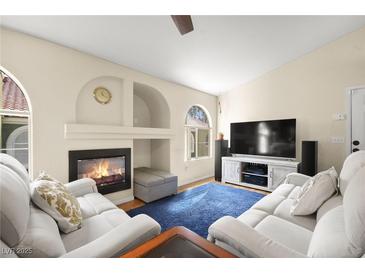 Inviting living room features a cozy fireplace and comfortable seating on a soft blue rug at 7950 W Flamingo Rd # 2142, Las Vegas, NV 89147
