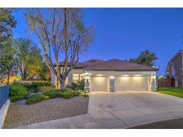 Charming home featuring a well-manicured front yard and a spacious three-car garage at 1900 Vero Dr, Las Vegas, NV 89134