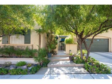 Charming home featuring mature landscaping and a welcoming entrance with gated courtyard and two car garage at 2279 Pacini Ct, Henderson, NV 89052