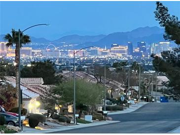 Night view of the Las Vegas strip and skyline over a residential neighborhood at 2736 Darby Falls Dr, Las Vegas, NV 89134