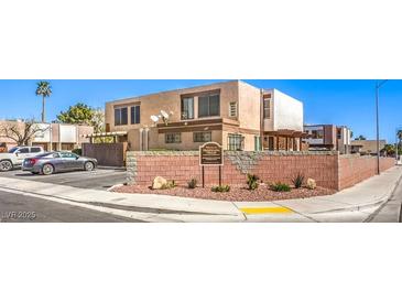 A welcoming exterior view of a multi-Gathering building with desert landscaping and community signage at 3683 Villa Knolls East Dr, Las Vegas, NV 89120