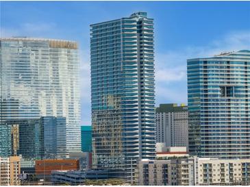 Exterior shot of modern high-rise buildings with unique architectural designs against a clear blue sky at 4471 Dean Martin Dr # 1207, Las Vegas, NV 89103
