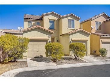 Inviting two-story home with a charming facade, dual car garage, and well-maintained landscaping at 5948 Sakhalin Ave, Las Vegas, NV 89139