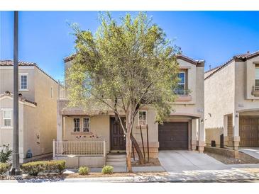 Charming two-story home featuring a cozy front porch and attached garage, showcasing a well-maintained facade at 9117 Careful Canvas Ave, Las Vegas, NV 89149