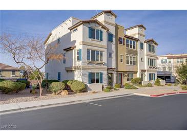 Attractive multi-level townhome featuring a stucco exterior, well-maintained landscaping, and convenient parking at 1329 Jewelstone Cir, Henderson, NV 89012