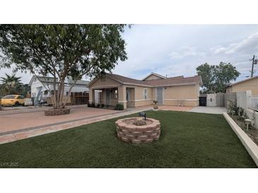 Charming home featuring a well-maintained front yard and a lovely decorative fire pit at 1910 Hoover St, North Las Vegas, NV 89030