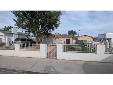 Charming single-story home with manicured front yard, secure fencing and a vintage-style mailbox at 1910 Hoover St, North Las Vegas, NV 89030
