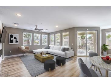 Bright living room featuring a modern sectional sofa, stylish decor, and sliding door access to a patio at 2555 Hampton Rd # 4204, Henderson, NV 89052