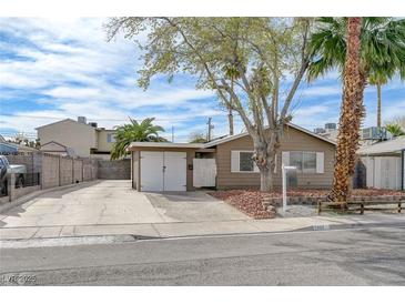 Charming single story home featuring a spacious driveway and a two-car garage at 5065 Atherton St, Las Vegas, NV 89120
