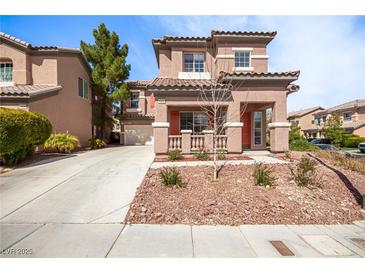 Inviting two-story home featuring a neutral color palette, well-kept landscaping, and a spacious driveway at 5932 Lamotte Ave, Las Vegas, NV 89141