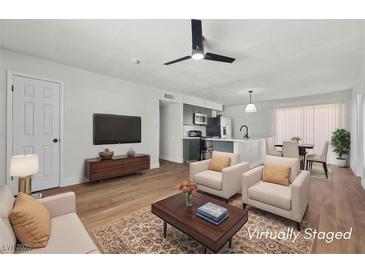 Bright, staged living room boasts a ceiling fan and updated decor at 728 Carpenter Dr, Las Vegas, NV 89107