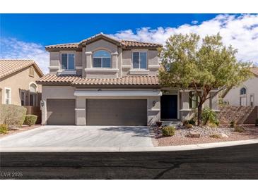 Charming two-story home featuring a three-car garage and landscaped front yard at 11484 Roncat Ct, Las Vegas, NV 89141