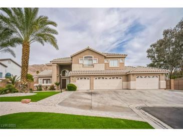 Elegant two-story home with a well-manicured lawn, palm tree, and a spacious driveway leading to multiple garages at 1304 Husson Ct, Las Vegas, NV 89142