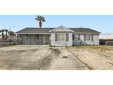 Charming single-story home featuring a spacious front yard and a unique horizontally slatted privacy enclosure at 1701 Linden Ave, Las Vegas, NV 89101