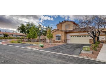Inviting two-story home featuring desert landscaping, a two-car garage, and ample parking at 228 Lorryn Ln # 2, Boulder City, NV 89005