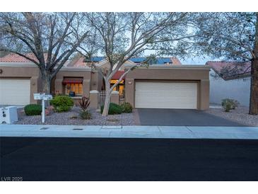 Charming single-story home featuring a two-car garage and mature landscaping at 2508 Palmridge Dr, Las Vegas, NV 89134