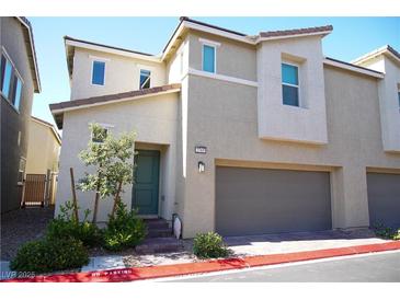 Charming two-story home with a two-car garage, xeriscape landscaping, and light-colored facade at 2765 Frosted Teal Ave, North Las Vegas, NV 89086