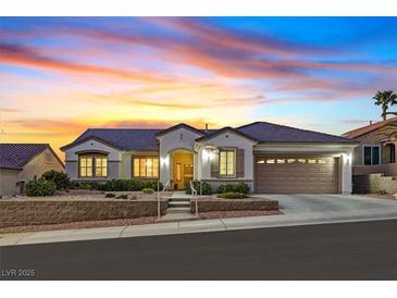 Charming single-story home with a well-manicured front yard and a two-car garage under a lovely sunset at 3042 Lake Barkley Rd, Henderson, NV 89052