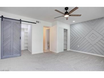 Spacious main bedroom featuring a ceiling fan, closet and ensuite bathroom at 3319 Royce Ct, Las Vegas, NV 89121