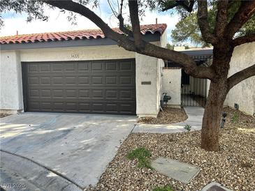 Charming single-story home with a brown garage door, desert landscaping, and a welcoming entrance at 3422 Pino Cir, Las Vegas, NV 89121