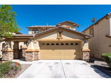 Charming single-Gathering home featuring a two-car garage and a well-maintained front yard at 6036 Sierra Lakes St, North Las Vegas, NV 89031