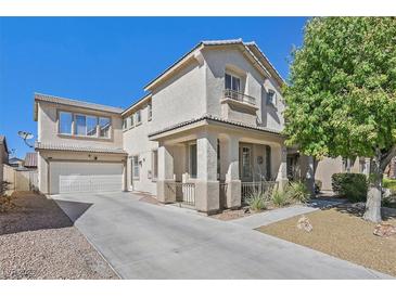 Charming two-story home features a covered porch, attached garage, and a well-manicured front yard at 748 Canfield Point Ave, Las Vegas, NV 89183